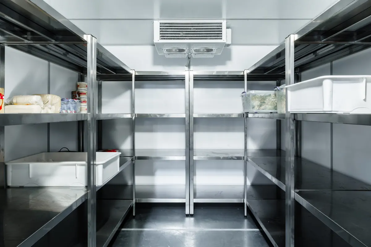 Inside a walk in cold room with steel shelving fitted by Fridges Direct in a restaurant
