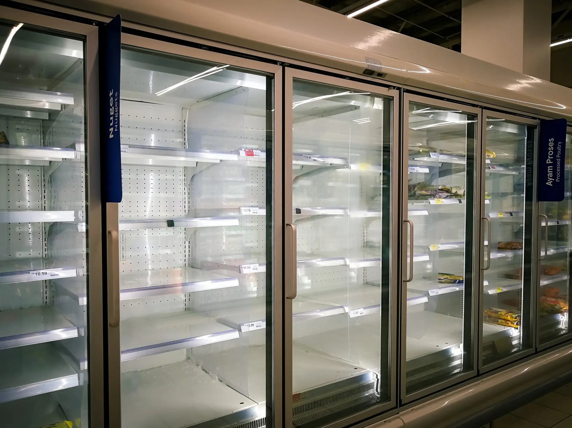 Row of commercial upright freezer cabinets in a supermarket supplied by Fridges Direct